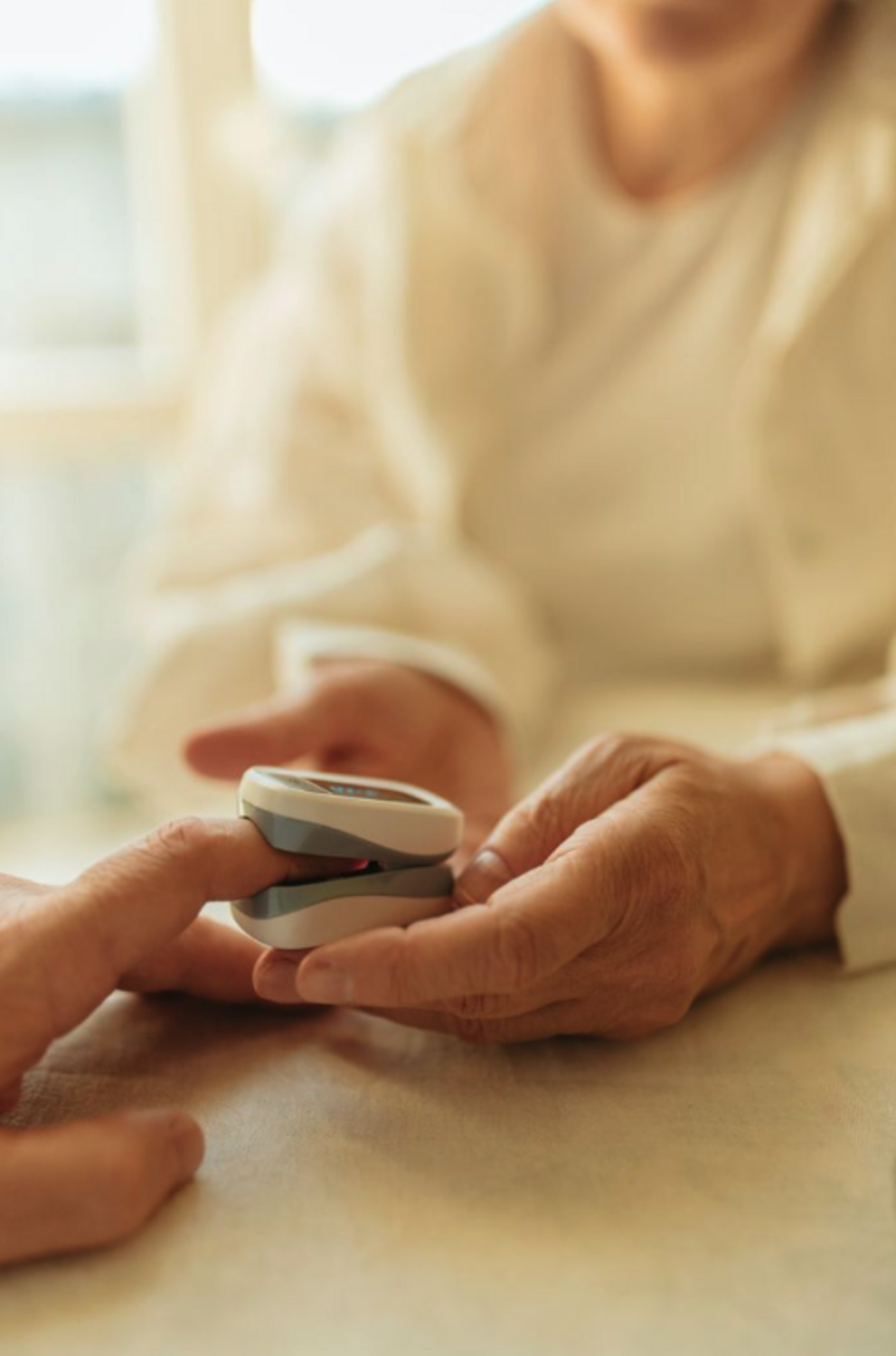 Older adult using a fingertip health monitor